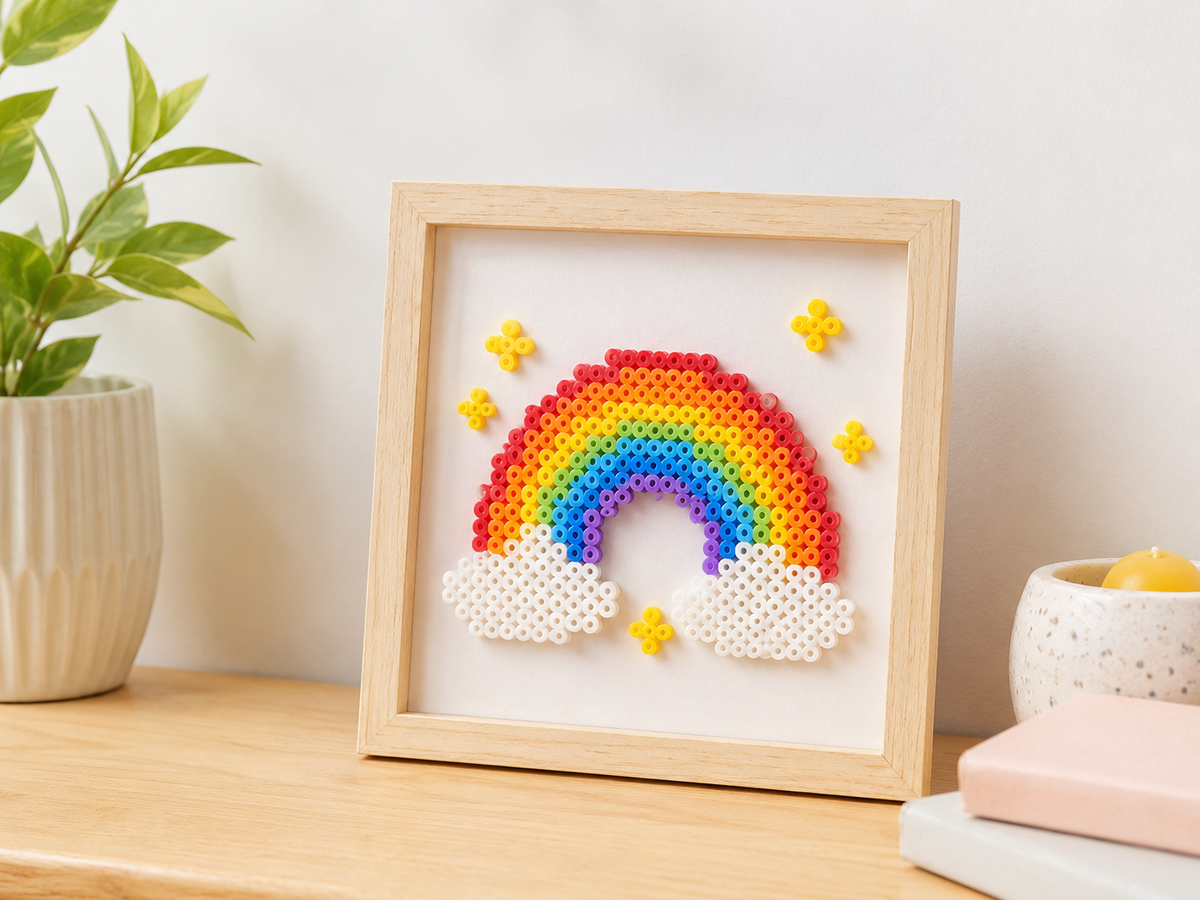 Framed rainbow fuse bead artwork displayed on a wooden shelf